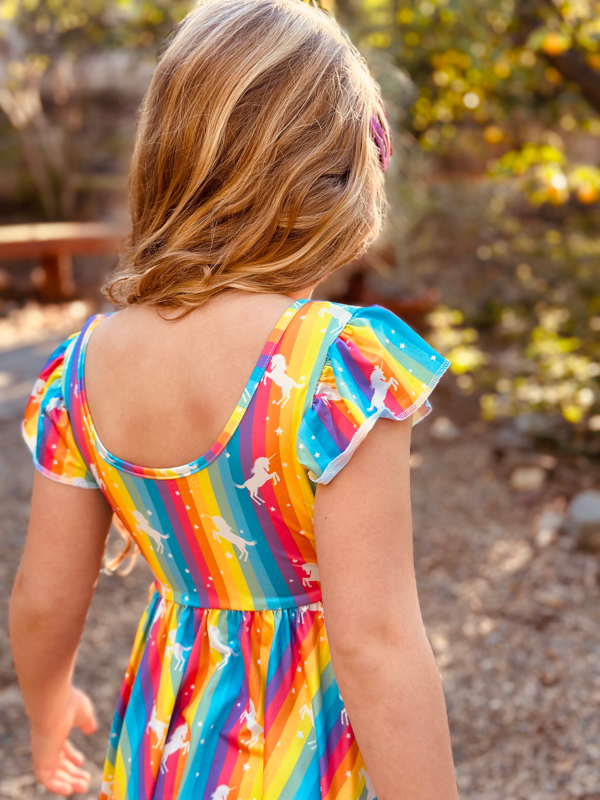 Back view of rainbow unicorn empire dress