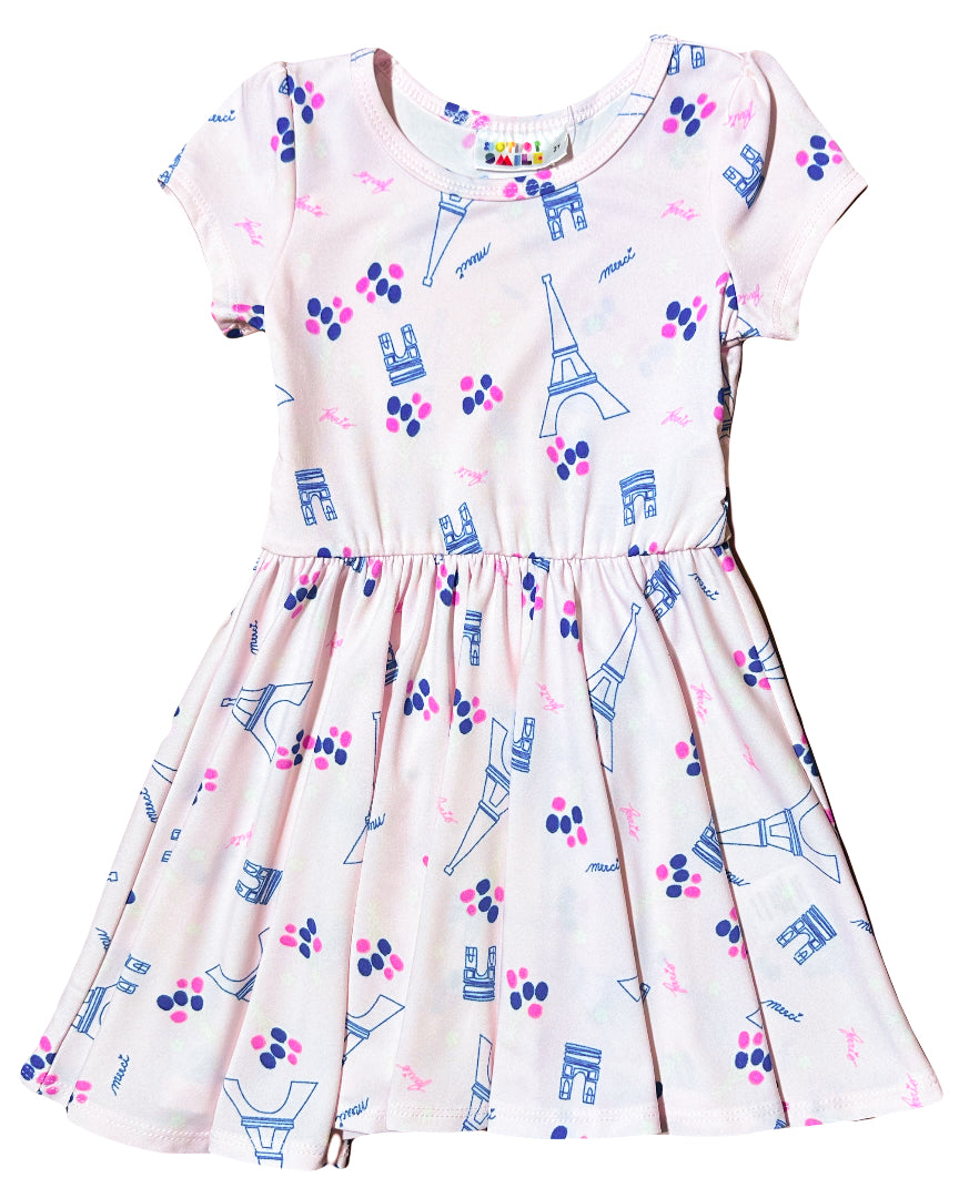 DotDotSmile Cap Dress with Paris-themed print and French icons – flat lay